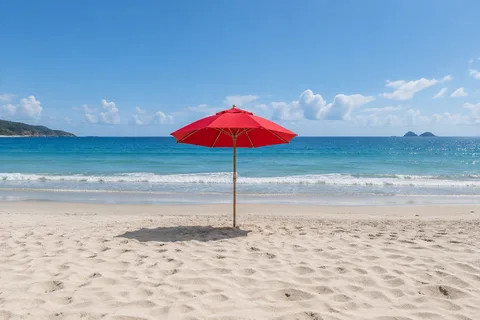 Before: A red umbrella disappears from a beach.